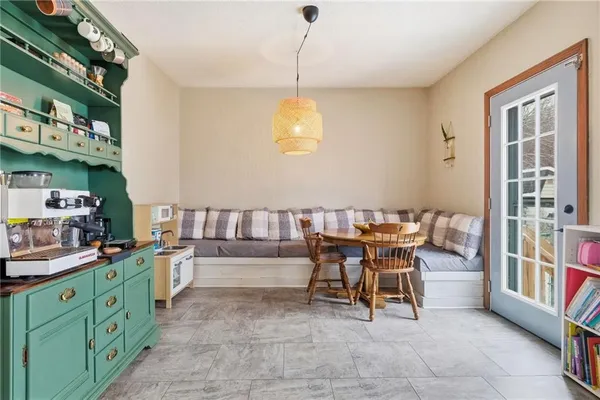 a kitchen with refrigerator a stove a sink and chairs