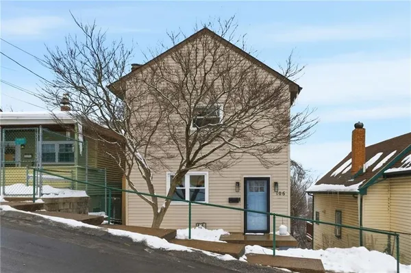 a view of a house with a snow on the road