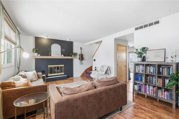 a living room with furniture and a fireplace