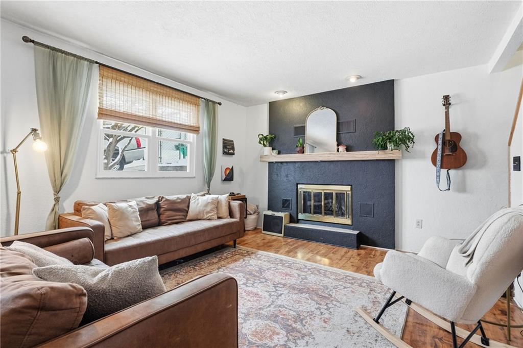 106 Logan Street Pittsburgh, PA 15209 - Photo 7 of 40 a living room with furniture and a fireplace