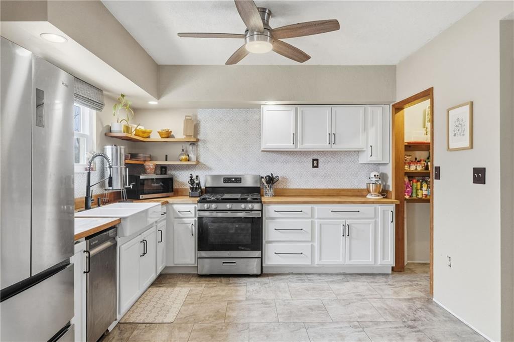 106 Logan Street Pittsburgh, PA 15209 - Photo 10 of 40 a kitchen with stainless steel appliances granite countertop a stove sink and refrigerator