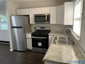 a kitchen with a refrigerator stove and microwave