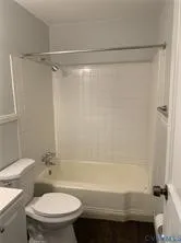 a bathroom with a shower a toilet and a sink