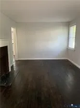 a view of room with hardwood floor and cabinet