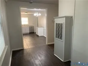 a view of a room with wooden floor and a window