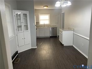 3324 Meadowbridge Road Richmond, VA 23222 - Photo 8 of 38 a view of a kitchen with a sink dishwasher wooden floor and a window