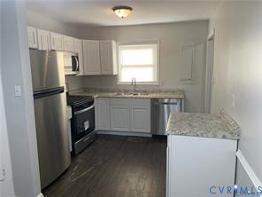 3324 Meadowbridge Road Richmond, VA 23222 - Photo 10 of 38 a kitchen with stainless steel appliances granite countertop a sink stove and refrigerator