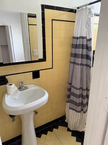 a kitchen with granite countertop a sink a stove and a microwave