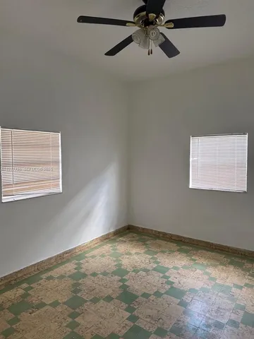 a view of empty room with a fireplace