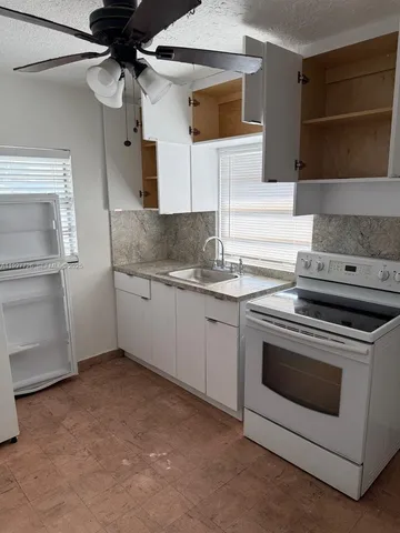 a bathroom with a sink a mirror and shower