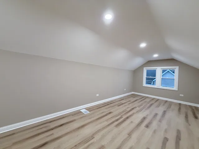 a view of room with window and hardwood floor
