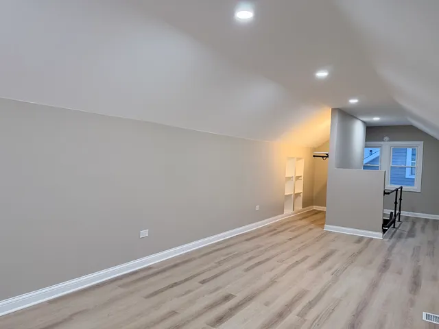 a view of a room with wooden floor and furniture