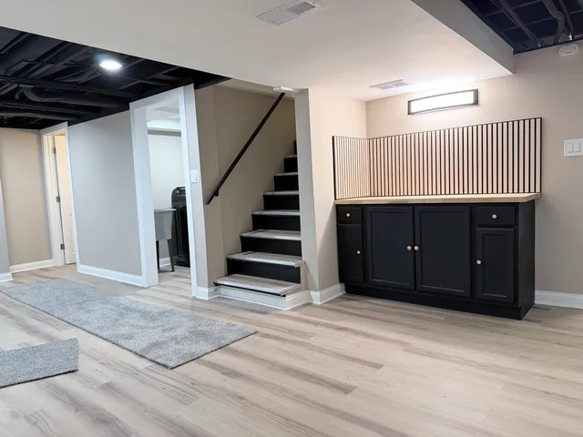 a view of a livingroom with stairs and furniture