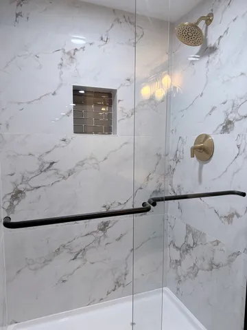 a bathroom with a bathtub and shower