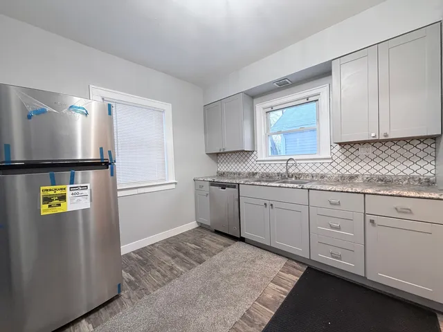 a kitchen with granite countertop cabinets and window