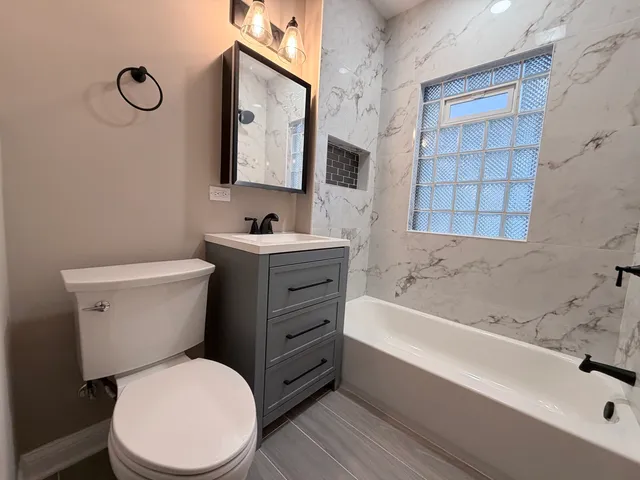 a bathroom with a toilet a sink and bathtub