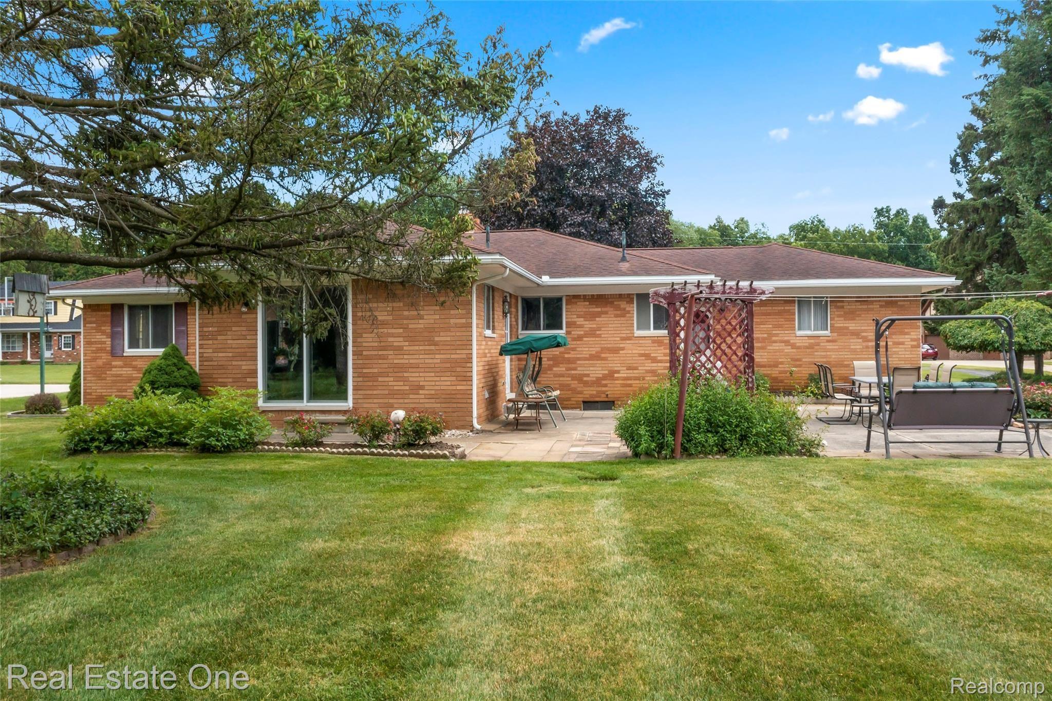 5360 Greenfield Road Brighton, MI 48114 - Photo 9 of 44 Brick exterior. Door wall off family room to patio.