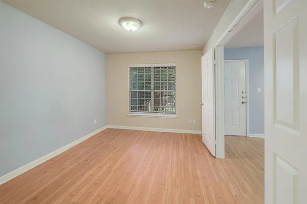 a view of a kitchen with wooden floor and a kitchen