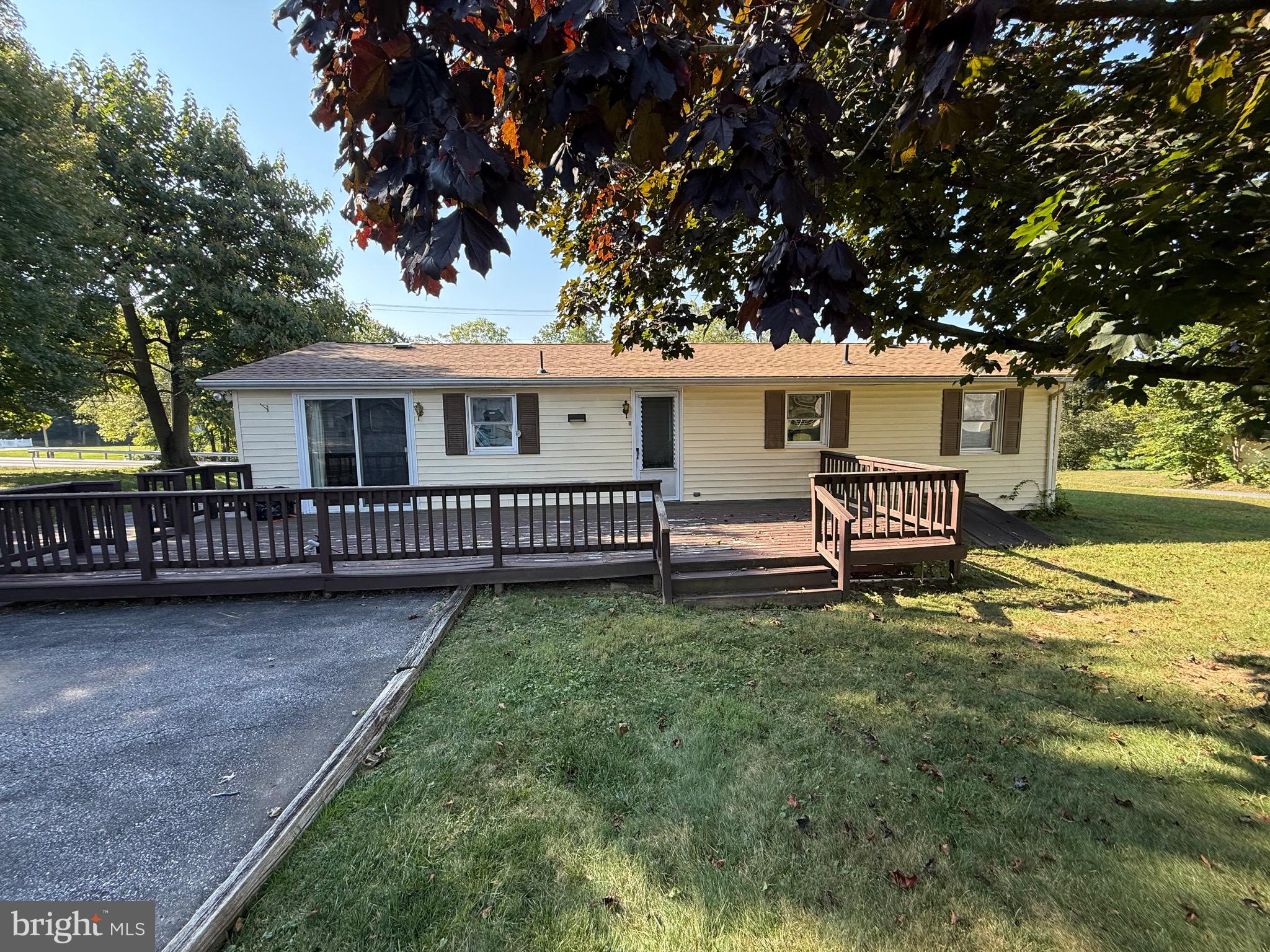 3424 Hampstead Mexico Road Hampstead, MD 21074 - Photo 9 of 26 a view of a chair and table on the wooden deck