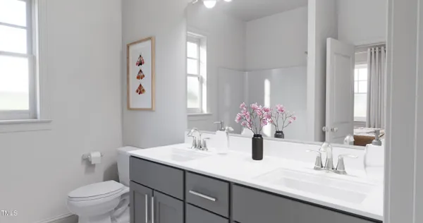 a bathroom with a sink a toilet and a large mirror