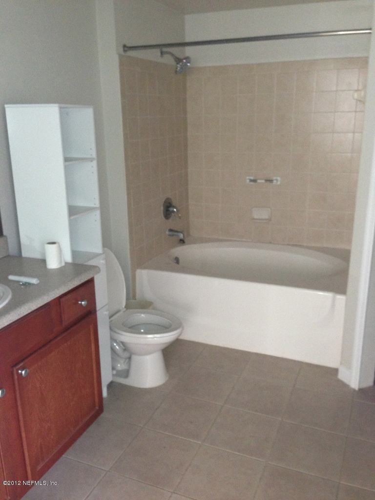 8550 Touchton Road, Unit 717 Jacksonville, FL 32216 - Photo 15 of 15 a bathroom with a toilet a sink and shower