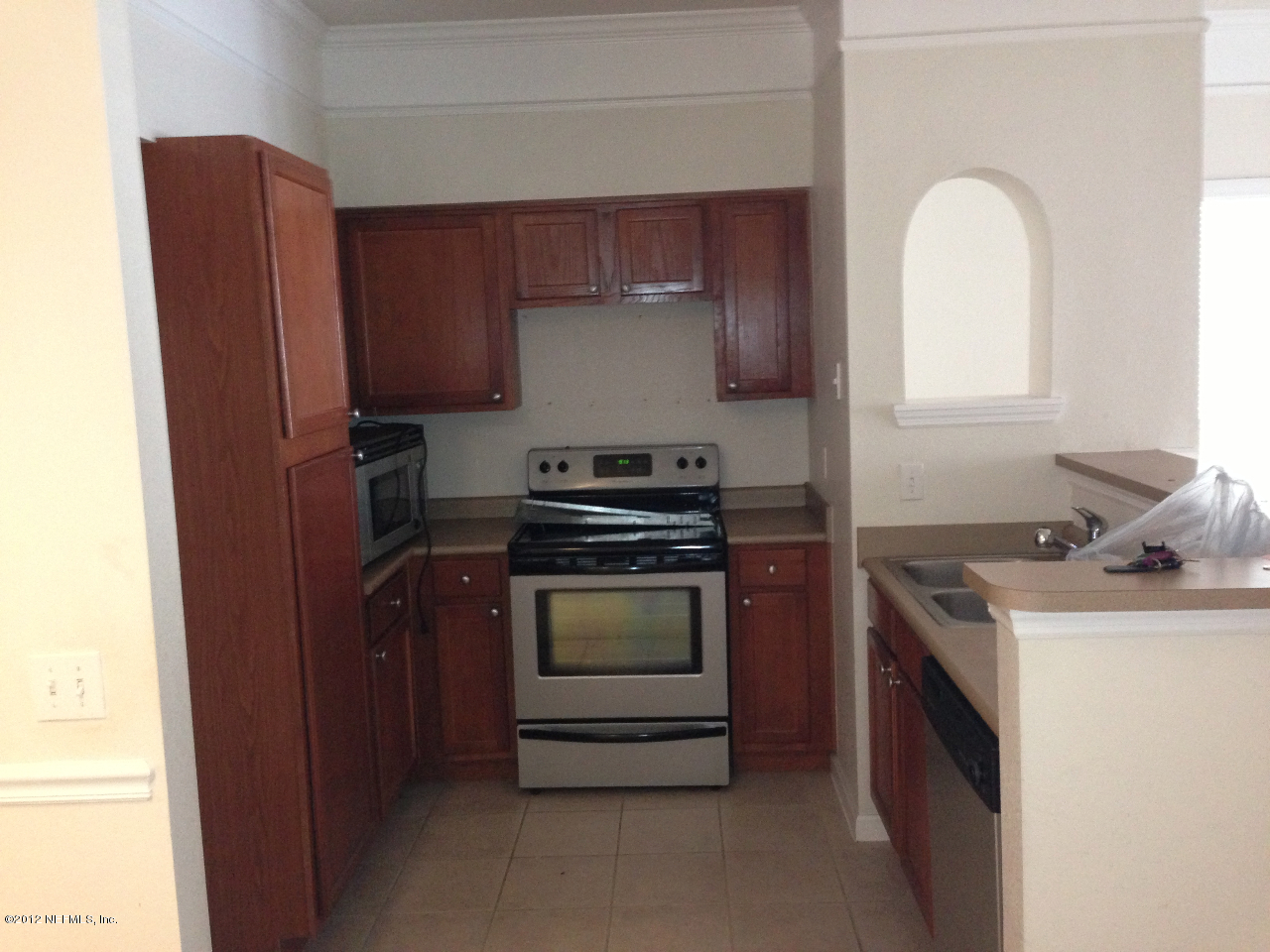 8550 Touchton Road, Unit 717 Jacksonville, FL 32216 - Photo 4 of 15 a kitchen with a stove and a refrigerator