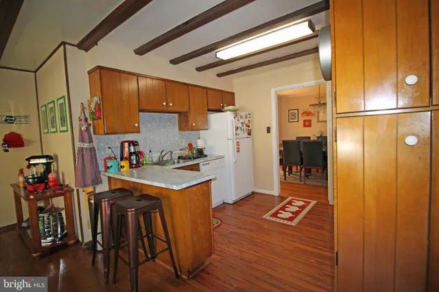a kitchen with stainless steel appliances granite countertop a refrigerator and a stove