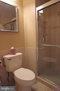 a bathroom with a toilet and a shower