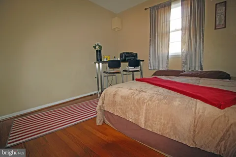 a bed sitting in a bedroom next to a window