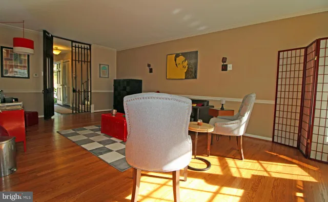 a living room with furniture a rug and wooden floor