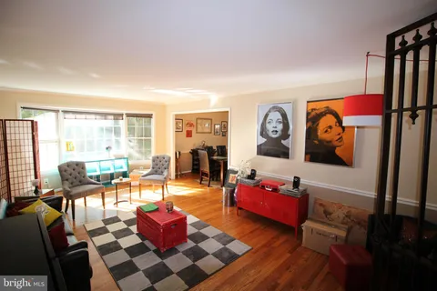 a living room with furniture a rug and a large window