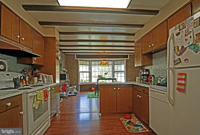 a kitchen with lots of counter top space and wooden floor