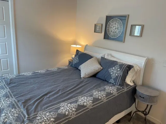 a bed sitting in a bedroom and chair