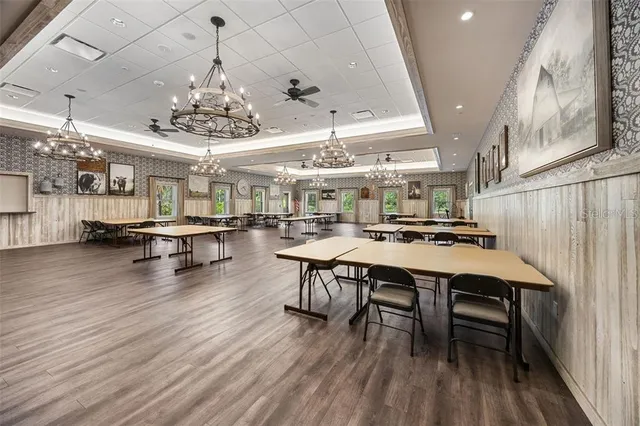 a view of a tennis ground with large trees