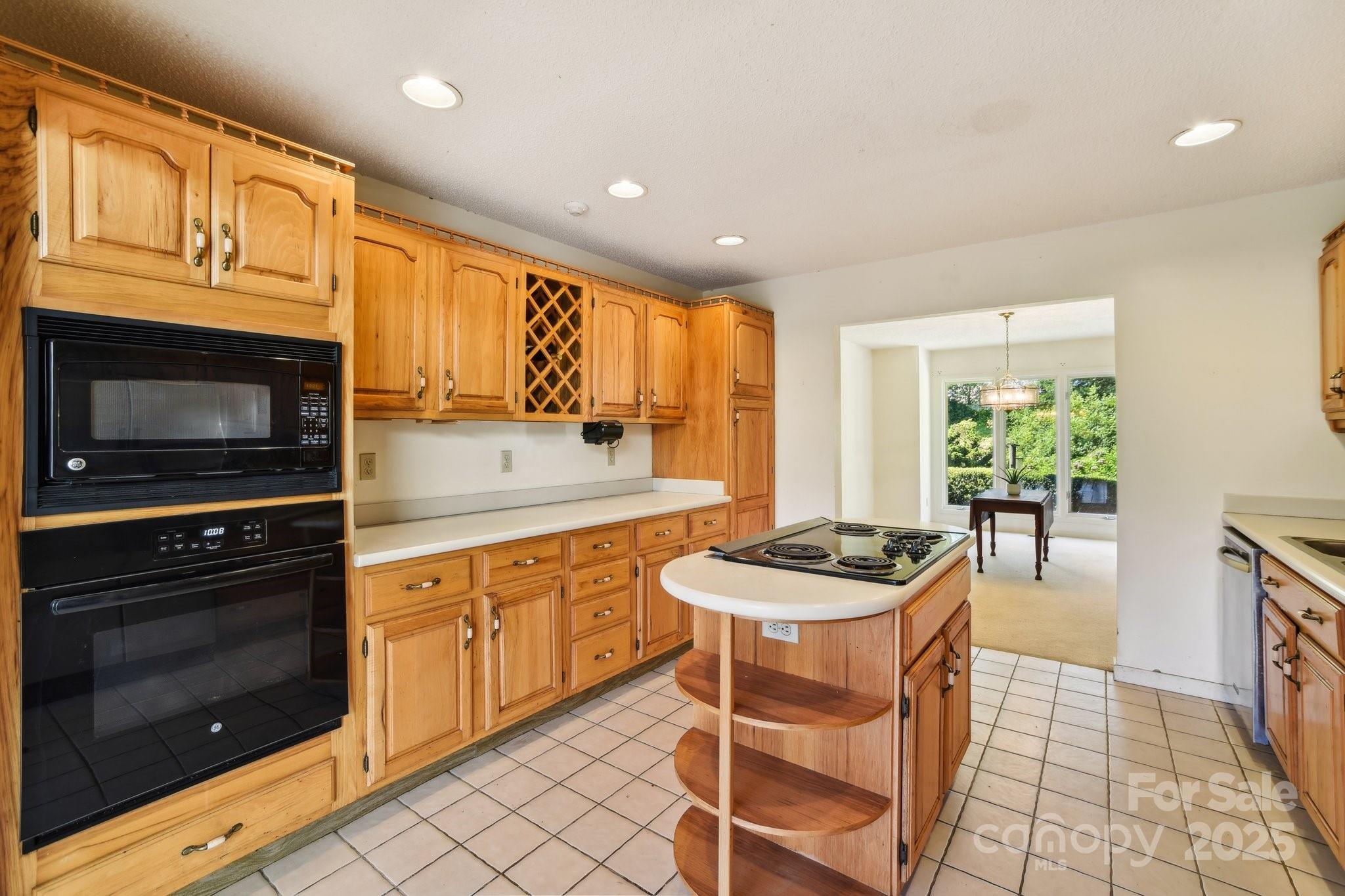 2281 Bearwallow Road Hendersonville, NC 28792 - Photo 11 of 46 a kitchen with a stove a sink and a microwave