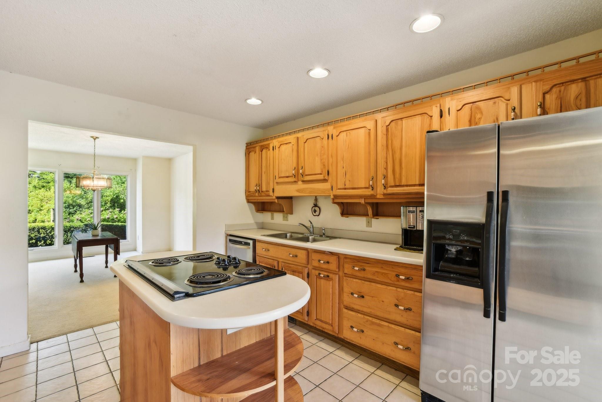 2281 Bearwallow Road Hendersonville, NC 28792 - Photo 12 of 46 a kitchen with stainless steel appliances granite countertop a stove a sink a refrigerator and island