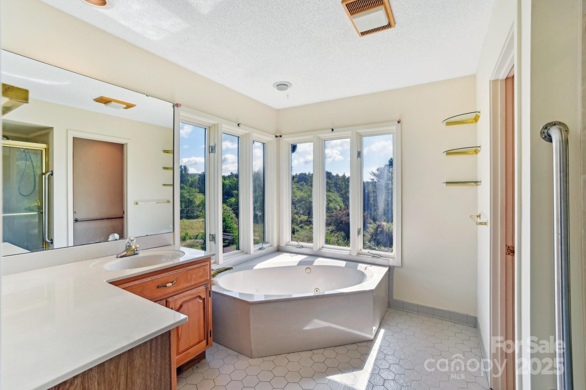 2281 Bearwallow Road Hendersonville, NC 28792 - Photo 17 of 46 a living room with a large window and a table