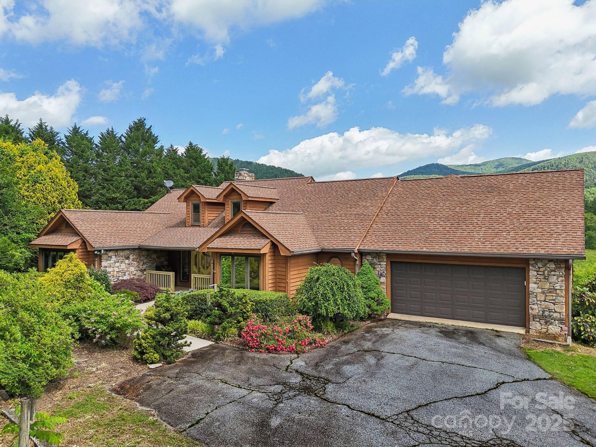 2281 Bearwallow Road Hendersonville, NC 28792 - Photo 2 of 46 a front view of a house with a garden