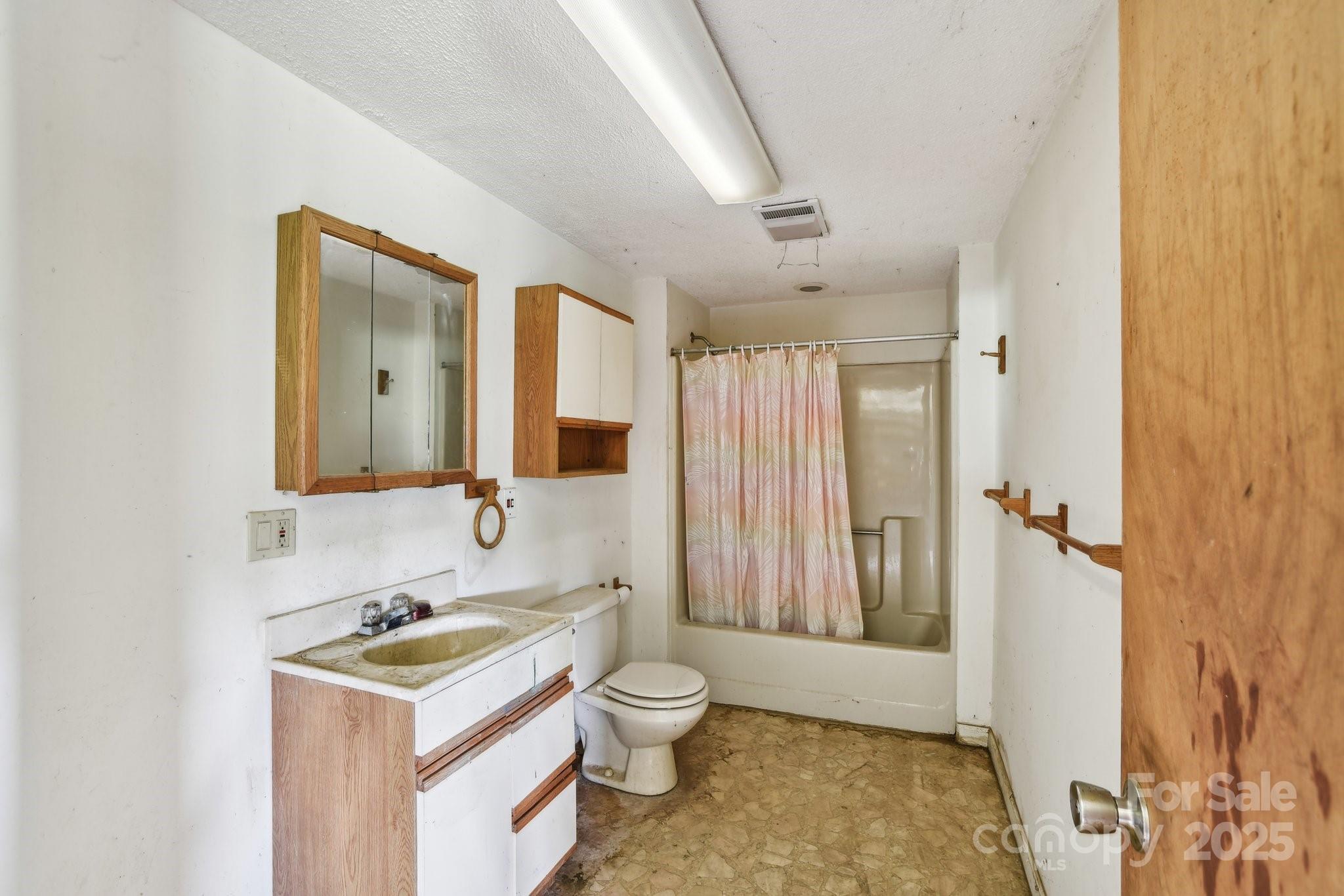 2281 Bearwallow Road Hendersonville, NC 28792 - Photo 27 of 46 a bathroom with a sink toilet double vanity and tub