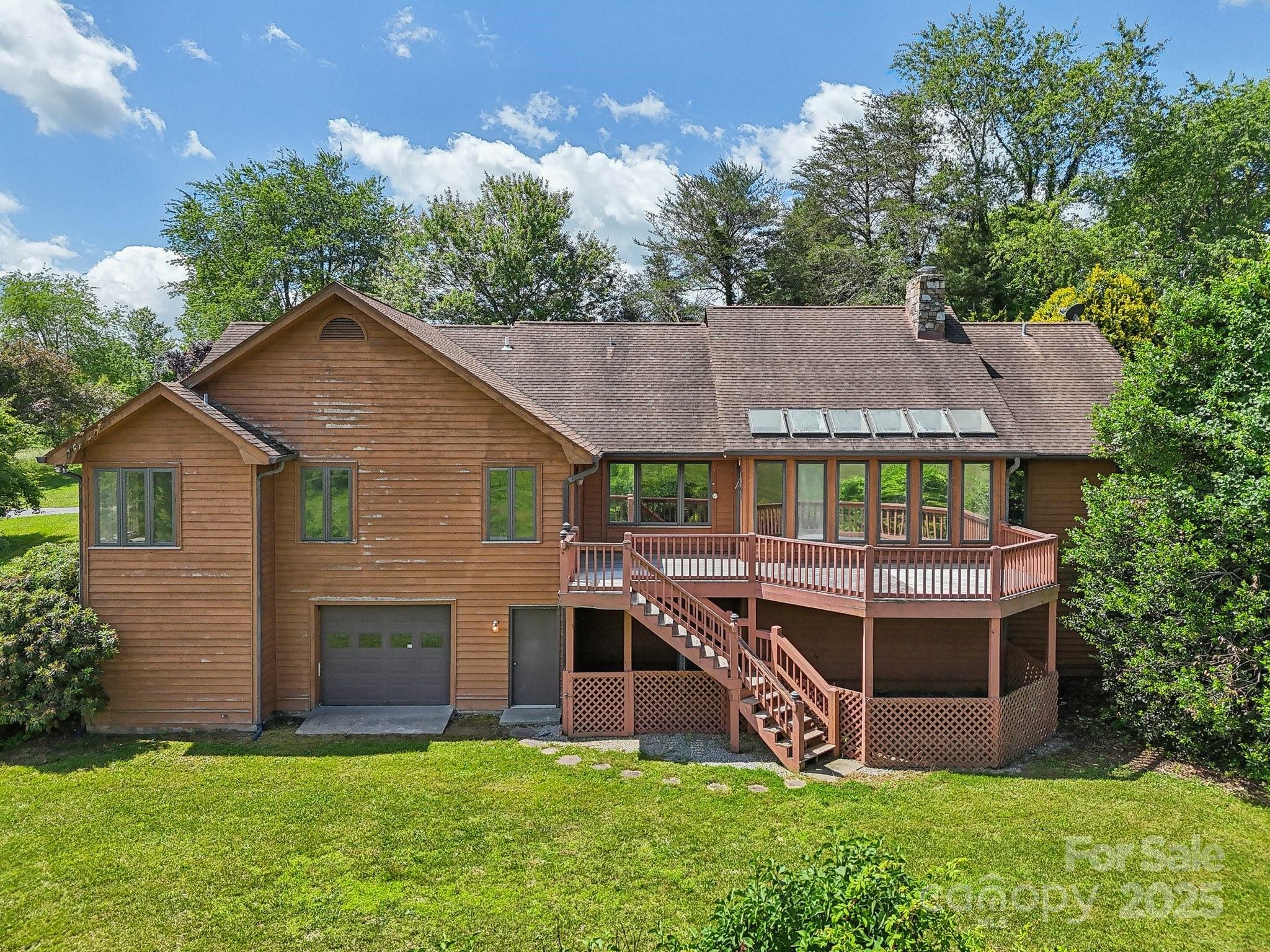 2281 Bearwallow Road Hendersonville, NC 28792 - Photo 41 of 46 a view of a house with a yard and sitting area