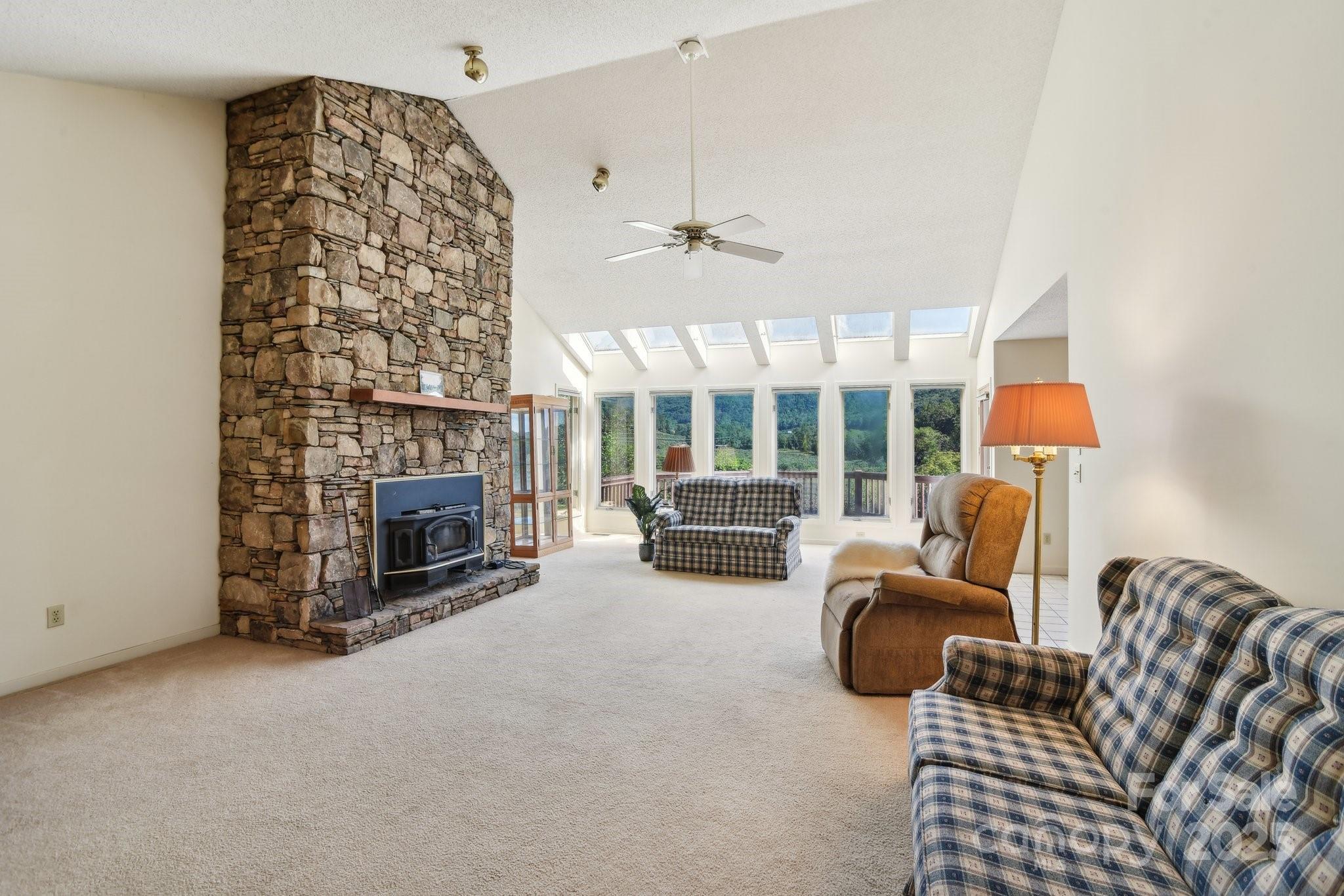 2281 Bearwallow Road Hendersonville, NC 28792 - Photo 5 of 46 a living room with furniture and a fireplace