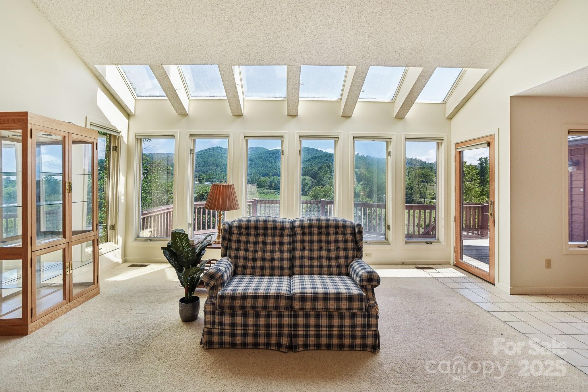 2281 Bearwallow Road Hendersonville, NC 28792 - Photo 6 of 46 a bedroom with furniture and large windows