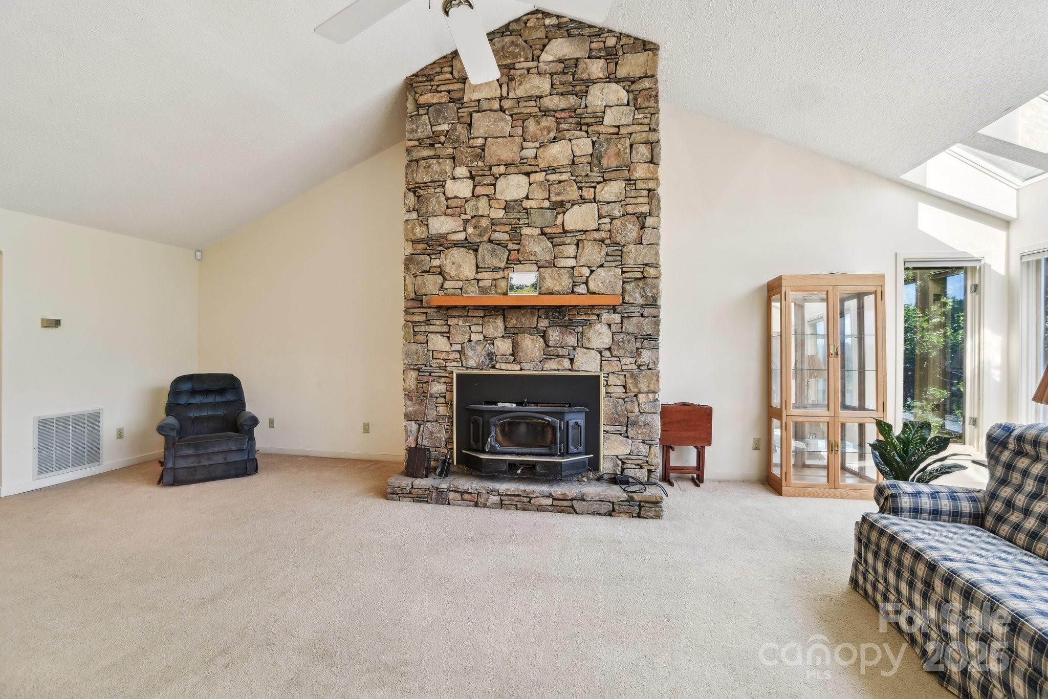 2281 Bearwallow Road Hendersonville, NC 28792 - Photo 7 of 46 a living room with furniture a fireplace and potted plants