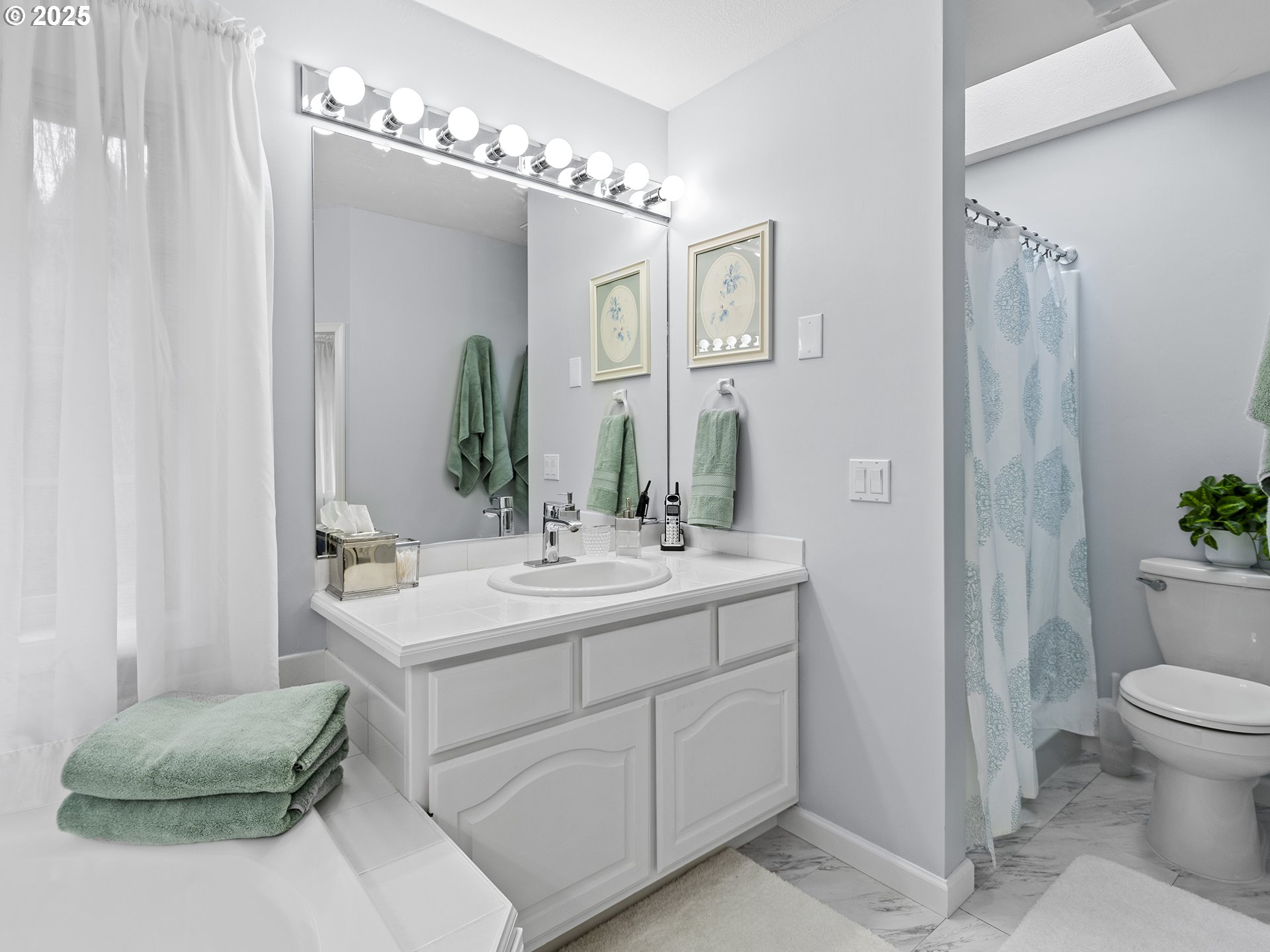 5906 Northwest 169th Street Ridgefield, WA 98642 - Photo 16 of 35 a en suite bathroom with a double vanity sink and a mirror