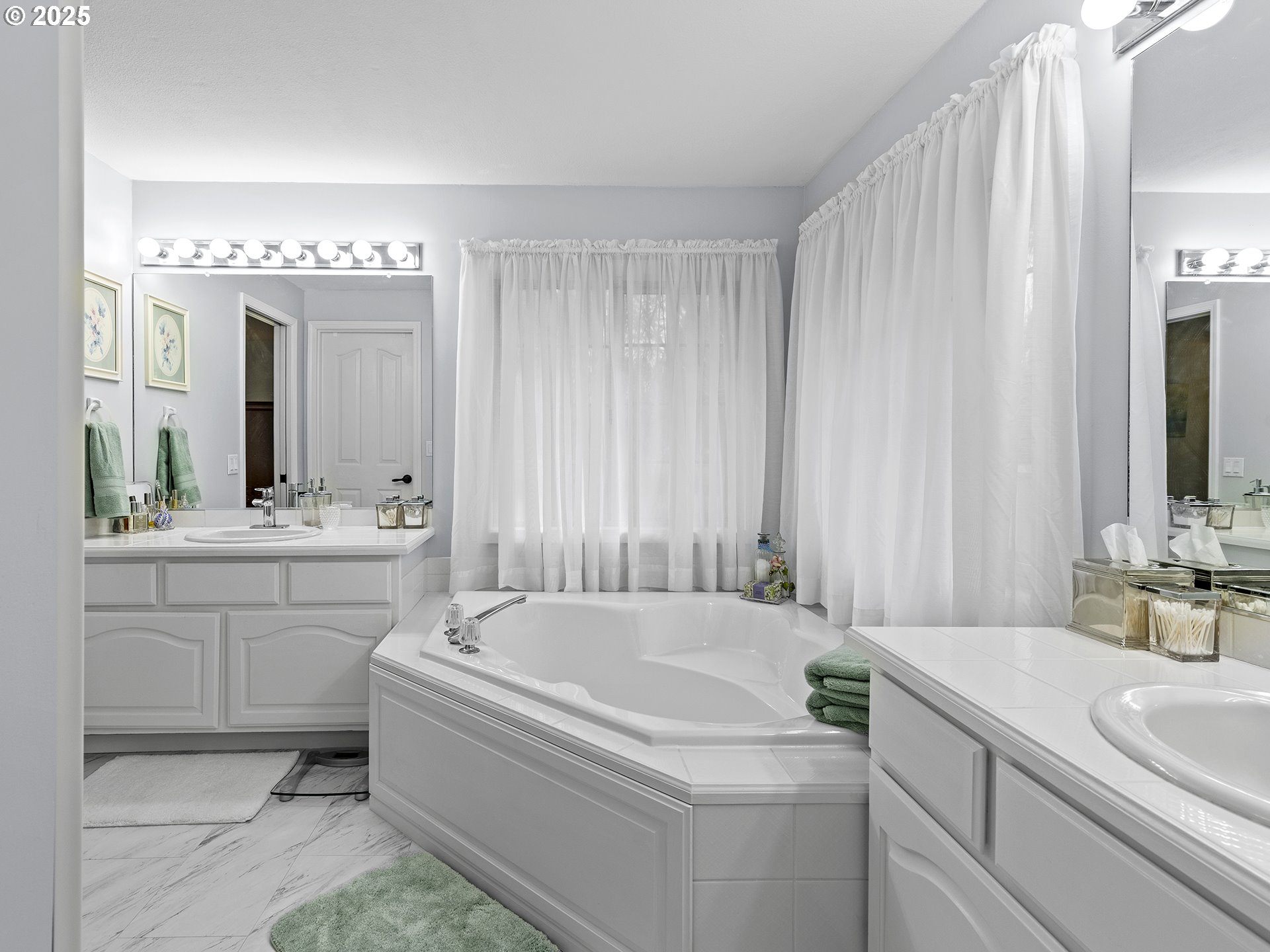 5906 Northwest 169th Street Ridgefield, WA 98642 - Photo 17 of 35 a spacious bathroom with a bathtub sink and mirror