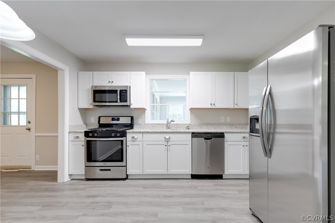 14911 Rowlett Road Chesterfield, VA 23838 - Photo 20 of 50 a kitchen with white cabinets and stainless steel appliances