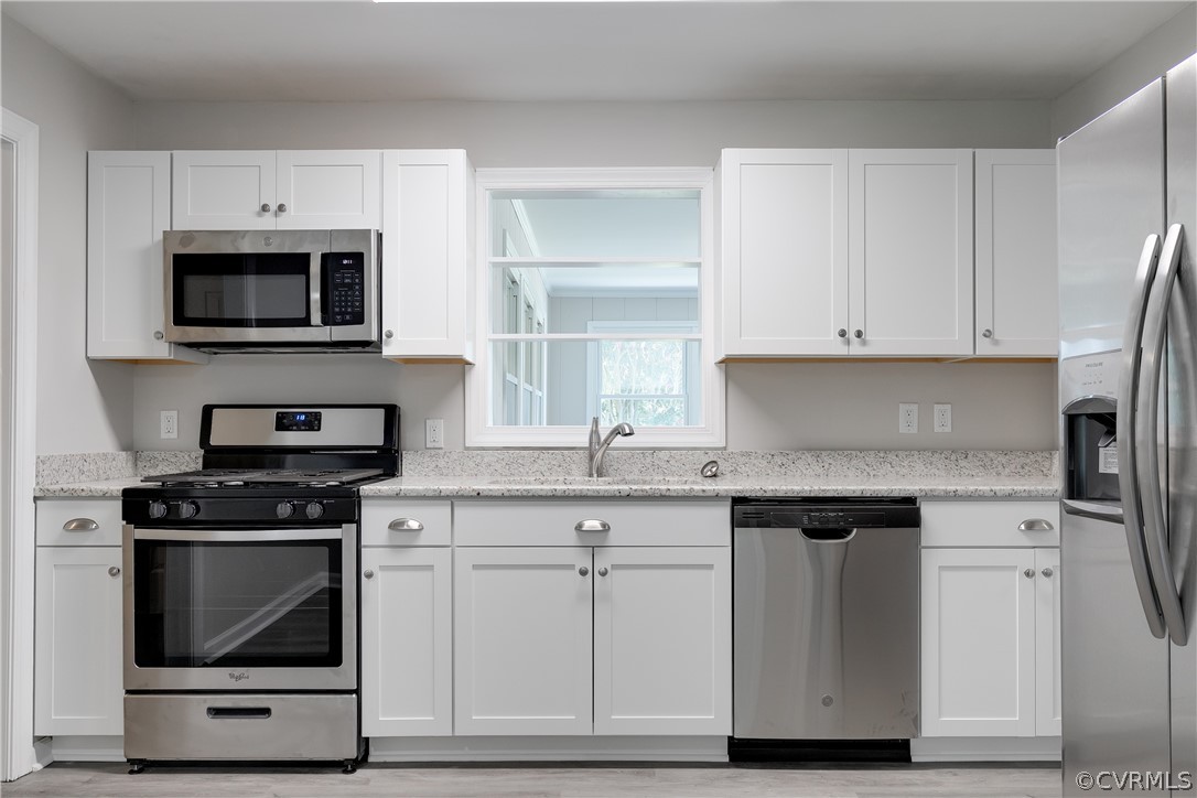 14911 Rowlett Road Chesterfield, VA 23838 - Photo 21 of 50 a kitchen with granite countertop white cabinets and black appliances
