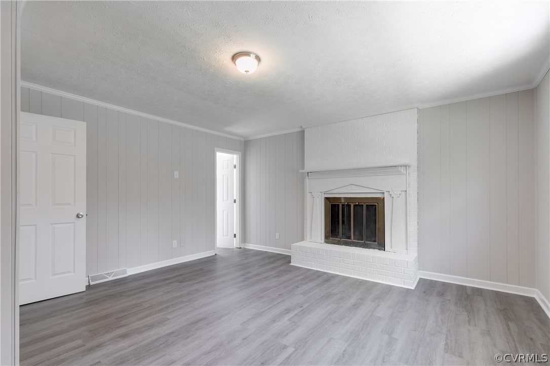 14911 Rowlett Road Chesterfield, VA 23838 - Photo 24 of 50 an empty room with wooden floor and fireplace
