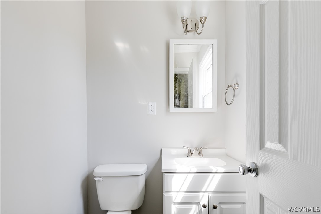 14911 Rowlett Road Chesterfield, VA 23838 - Photo 26 of 50 a bathroom with a toilet a sink and mirror