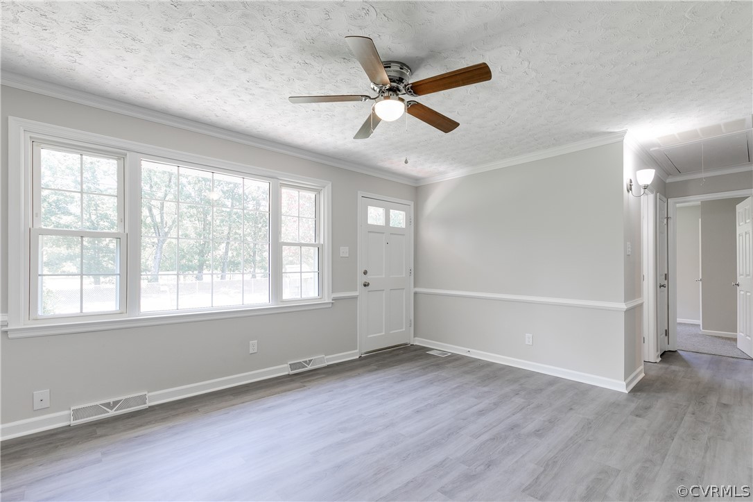 14911 Rowlett Road Chesterfield, VA 23838 - Photo 9 of 50 an empty room with wooden floor fan and windows